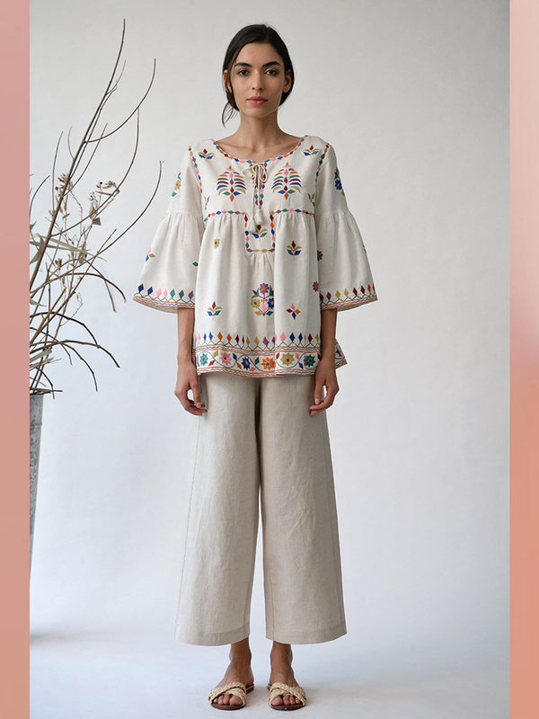 UMBAR by Payal Pratap   I   Top Mandvi  I  A Round Neck Tassle Tie Up Top With Peplum Sleeves And Intricate Thread Multicolour Embroideries From The Kutch Region  I  Perfect For Your Summer Day Out As Well As That Beach Getaway - Shop Cult Modern
