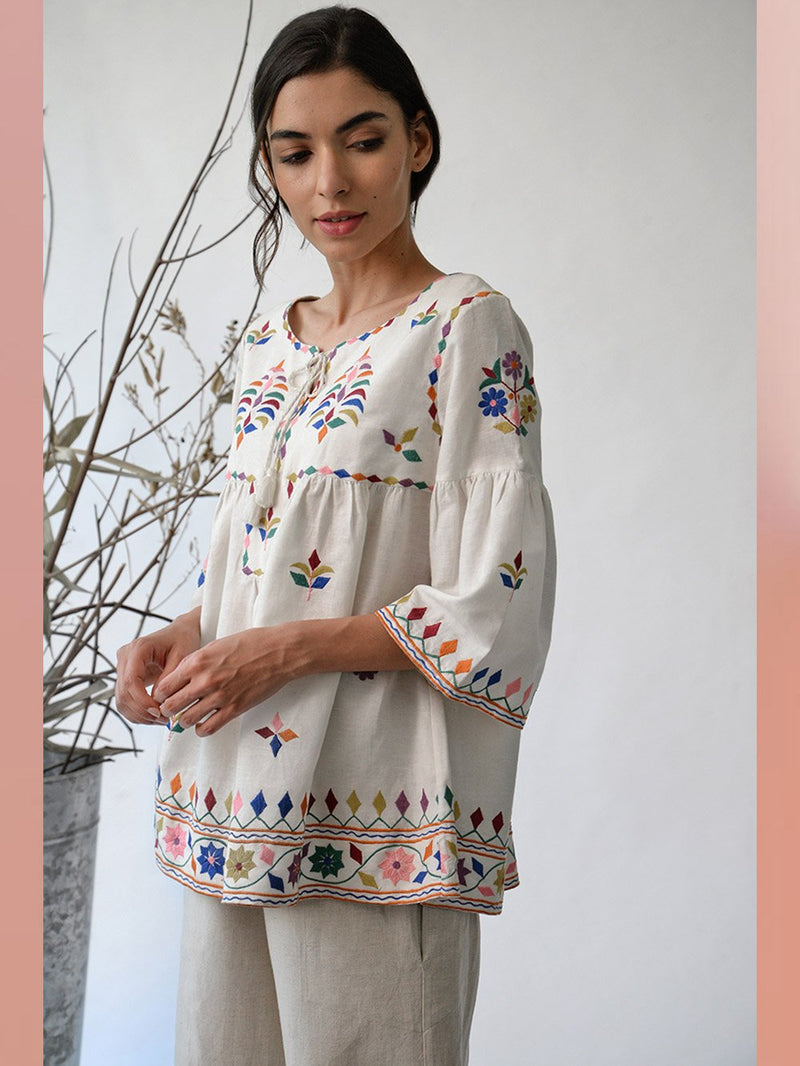 UMBAR by Payal Pratap   I   Top Mandvi  I  A Round Neck Tassle Tie Up Top With Peplum Sleeves And Intricate Thread Multicolour Embroideries From The Kutch Region  I  Perfect For Your Summer Day Out As Well As That Beach Getaway - Shop Cult Modern